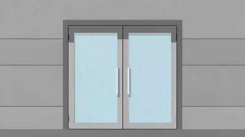 A modern bank branch entrance with glass doors and a stone facade