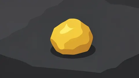 A rough, unrefined nugget of gold resting on a dark stone surface
