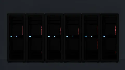 A row of black server racks with blinking status lights in a dimly lit data center
